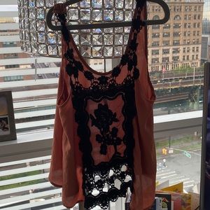 Burnt orange sleeveless blouse with lace detail on back
